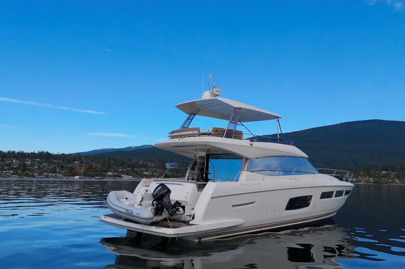 Luna Maris Yacht Photos Pics Luxury 2016 Prestige 550 yacht on serene water with scenic mountain backdrop.