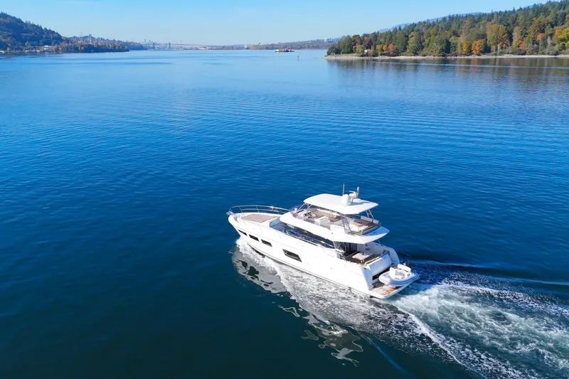 Luna Maris Yacht Photos Pics Luxury 2016 Prestige 550 yacht cruising on a serene blue lake.