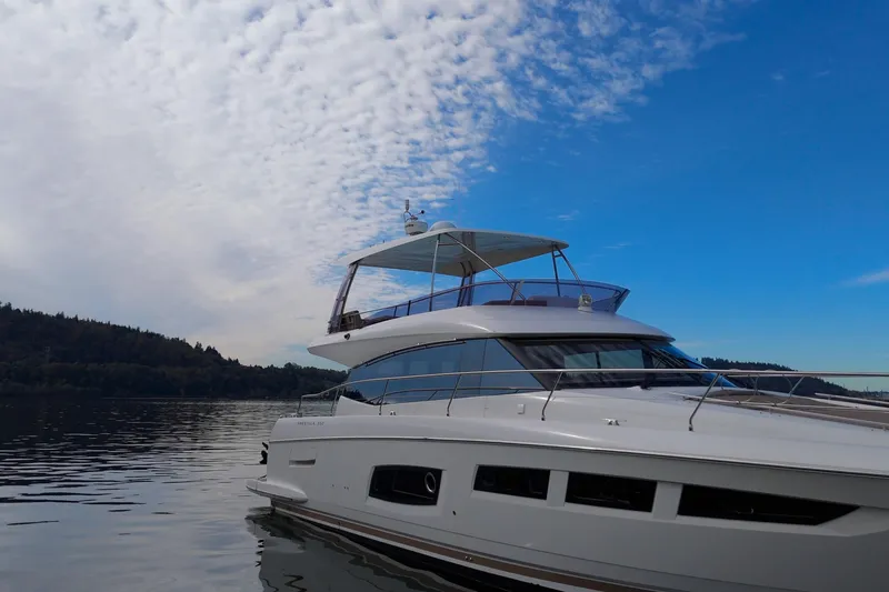 Luna Maris Yacht Photos Pics 2016 Prestige 550 yacht on calm water under a partly cloudy sky.