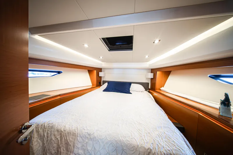 Luna Maris Yacht Photos Pics Luxurious cabin interior of 2016 Prestige 550 yacht with elegant bedding and modern lighting.