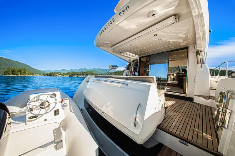 Luna Maris Yacht Photos Pics Luxurious 2016 Prestige 550 yacht on serene lake with scenic mountain backdrop.