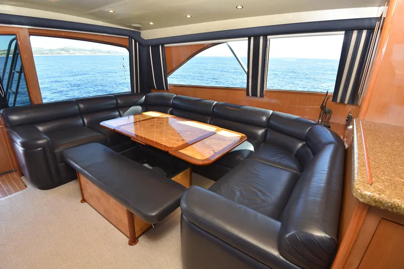 Bella Betty Yacht Photos Pics Luxurious interior of 2003 Viking 65 Enclosed Bridge yacht with leather seating and ocean view.