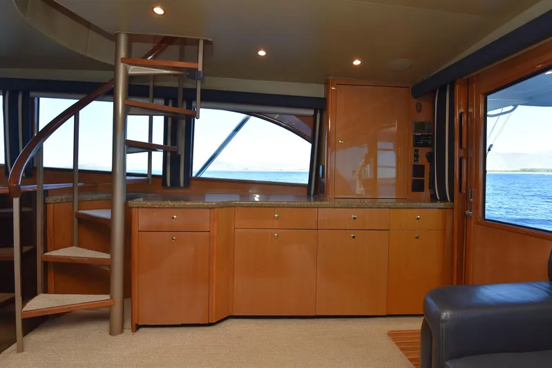 Bella Betty Yacht Photos Pics Interior of 2003 Viking 65 Enclosed Bridge yacht with spiral staircase and ocean view.