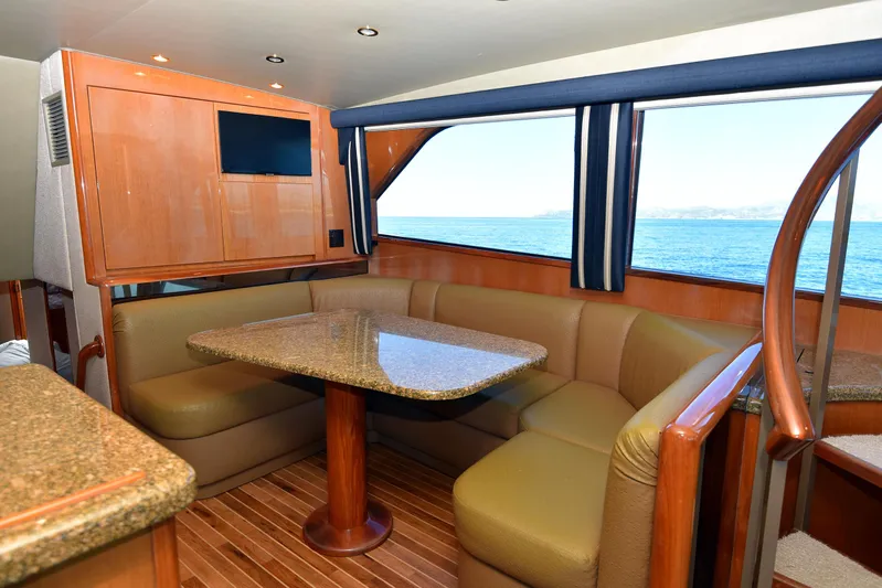 Bella Betty Yacht Photos Pics Interior of 2003 Viking 65 Enclosed Bridge yacht with dining area and ocean view.