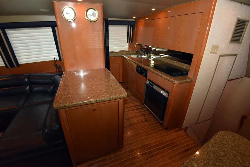 Bella Betty Yacht Photos Pics Interior of 2003 Viking 65 Enclosed Bridge yacht with modern kitchen and wood flooring.