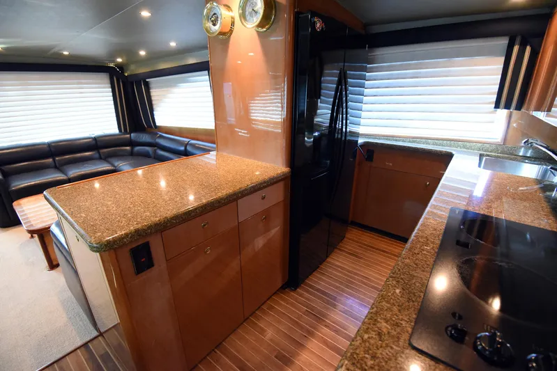 Bella Betty Yacht Photos Pics Luxurious interior of 2003 Viking 65 Enclosed Bridge yacht with modern kitchen and seating area.