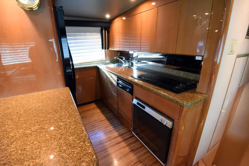 Bella Betty Yacht Photos Pics 2003 Viking 65 Enclosed Bridge yacht kitchen with modern appliances and wood cabinetry.