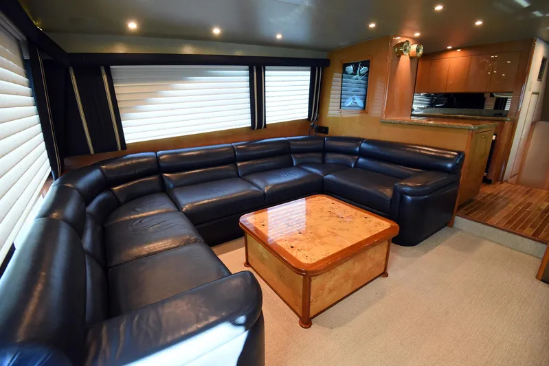 Bella Betty Yacht Photos Pics Luxurious interior of 2003 Viking 65 Enclosed Bridge yacht with leather seating and wooden table.