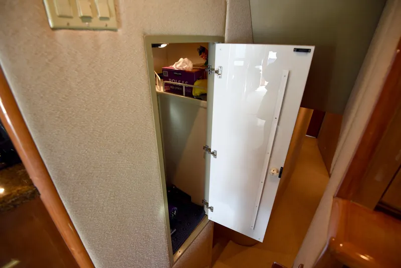 Bella Betty Yacht Photos Pics Open storage cabinet inside 2003 Viking 65 Enclosed Bridge yacht interior.