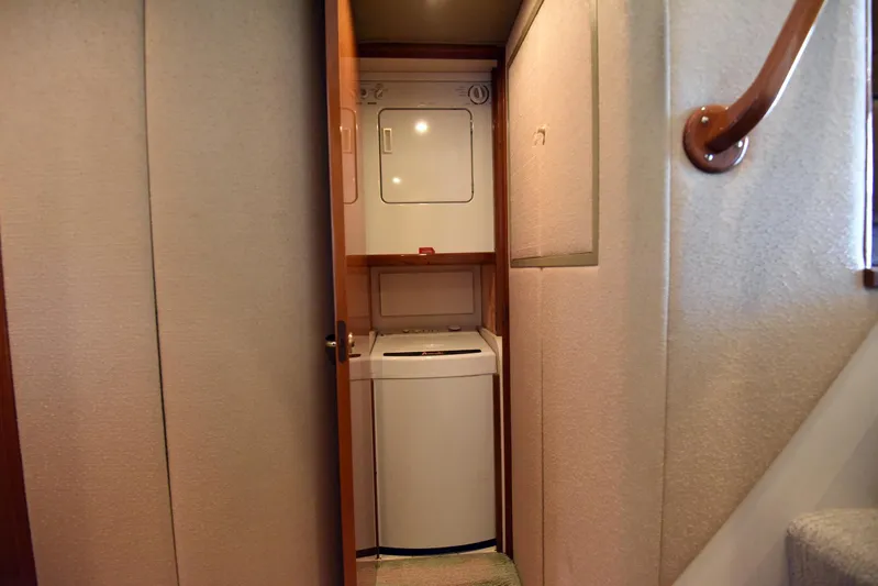 Bella Betty Yacht Photos Pics Laundry area inside 2003 Viking 65 Enclosed Bridge yacht, featuring washer and dryer.