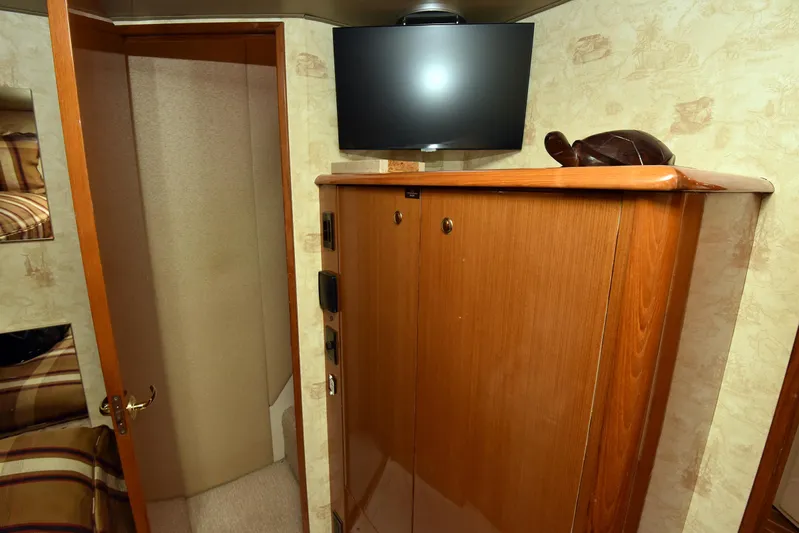 Bella Betty Yacht Photos Pics Interior of 2003 Viking 65 Enclosed Bridge yacht with TV and wooden cabinet.