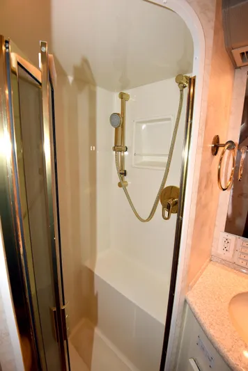 Bella Betty Yacht Photos Pics Shower area in 2003 Viking 65 Enclosed Bridge yacht with gold fixtures.