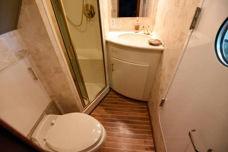 Bella Betty Yacht Photos Pics Bathroom interior of 2003 Viking 65 Enclosed Bridge yacht, featuring shower and wooden flooring.