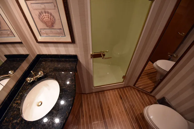 Bella Betty Yacht Photos Pics Luxurious bathroom in 2003 Viking 65 Enclosed Bridge yacht with elegant fixtures and wood flooring.