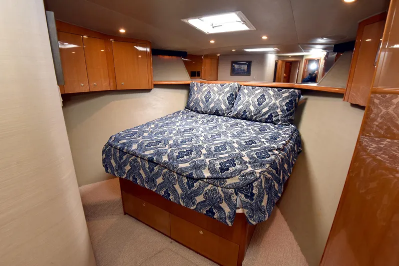 Bella Betty Yacht Photos Pics Luxurious bedroom interior of 2003 Viking 65 Enclosed Bridge yacht with patterned bedding.
