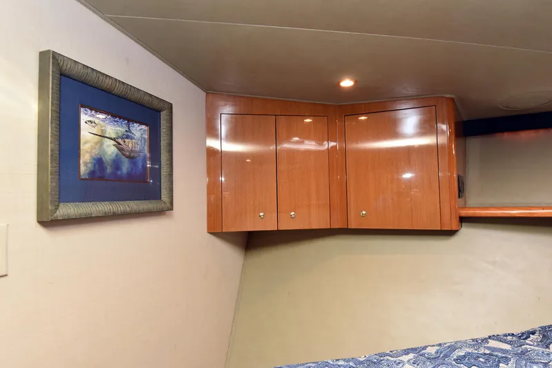 Bella Betty Yacht Photos Pics Interior of 2003 Viking 65 Enclosed Bridge with wooden cabinets and framed artwork.