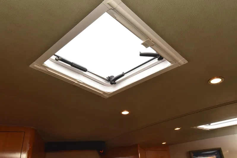 Bella Betty Yacht Photos Pics Ceiling hatch inside 2003 Viking 65 Enclosed Bridge yacht with recessed lighting.