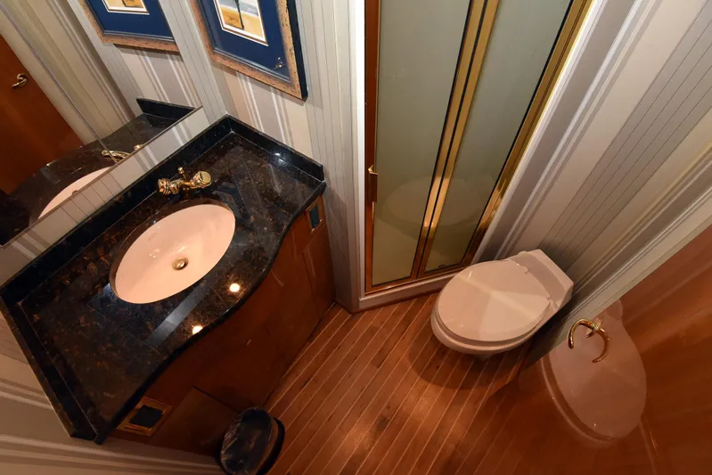 Bella Betty Yacht Photos Pics Bathroom interior of 2003 Viking 65 Enclosed Bridge yacht, featuring sink, toilet, and shower.