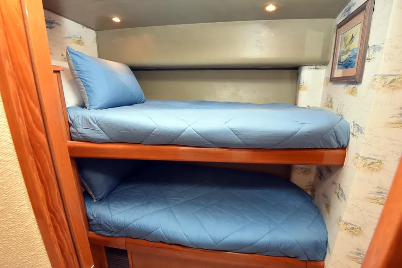Bella Betty Yacht Photos Pics Bunk beds with blue bedding in a 2003 Viking 65 Enclosed Bridge yacht cabin.