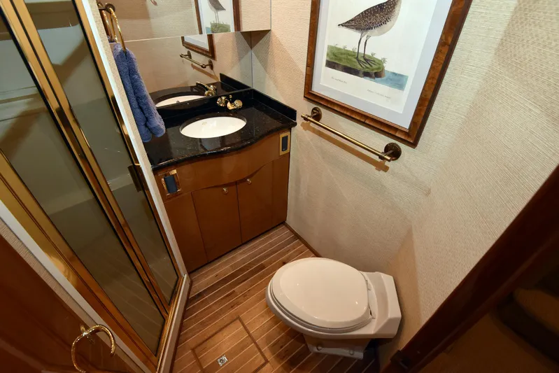 Bella Betty Yacht Photos Pics Luxurious bathroom in 2003 Viking 65 Enclosed Bridge yacht with elegant fixtures and wood accents.
