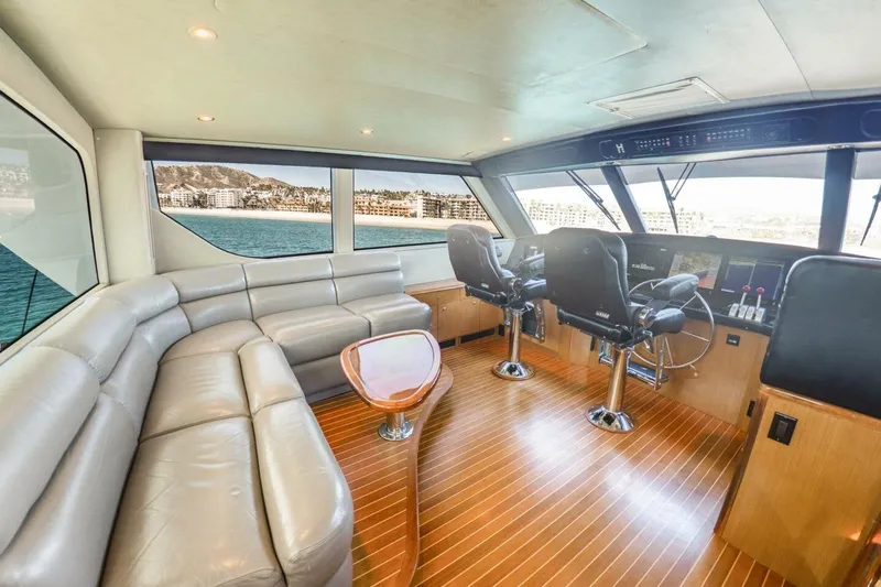 Bella Betty Yacht Photos Pics Luxurious interior of 2003 Viking 65 Enclosed Bridge yacht with leather seating and panoramic windows.