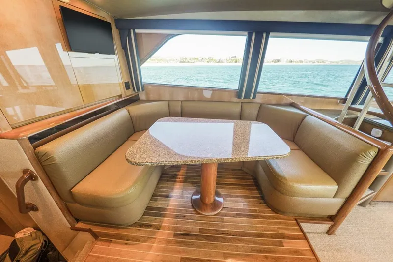 Bella Betty Yacht Photos Pics Luxurious interior of 2003 Viking 65 Enclosed Bridge yacht with leather seating and ocean view.