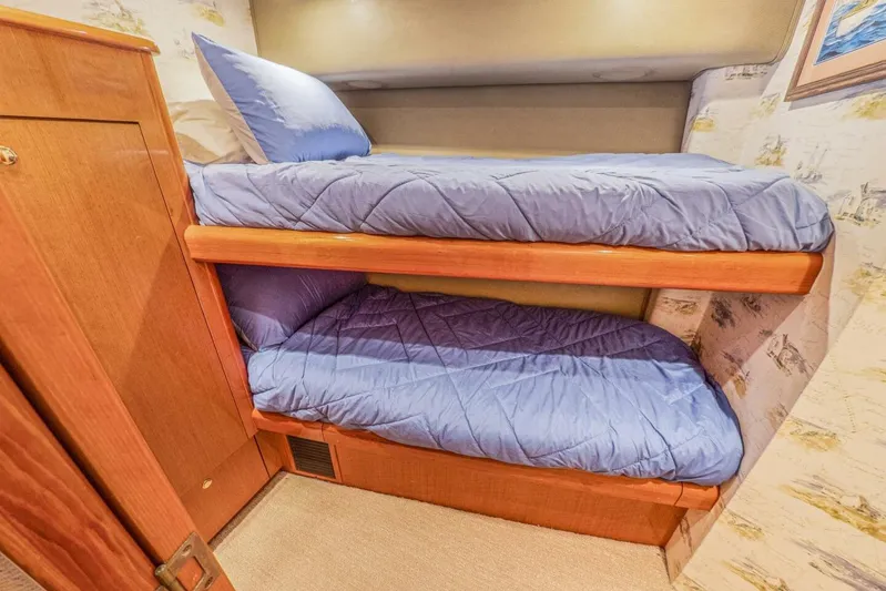 Bella Betty Yacht Photos Pics Bunk beds with blue bedding in 2003 Viking 65 Enclosed Bridge yacht cabin.