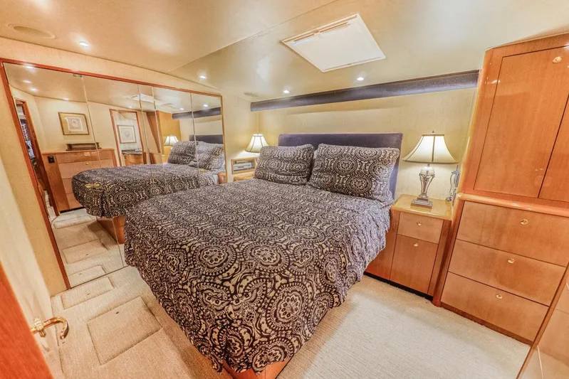 Bella Betty Yacht Photos Pics Luxurious bedroom interior of 2003 Viking 65 Enclosed Bridge yacht with elegant bedding and wood cabinetry.