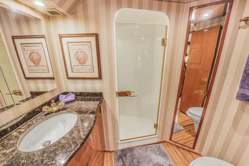 Bella Betty Yacht Photos Pics Luxurious bathroom in 2003 Viking 65 Enclosed Bridge yacht with elegant fixtures and decor.
