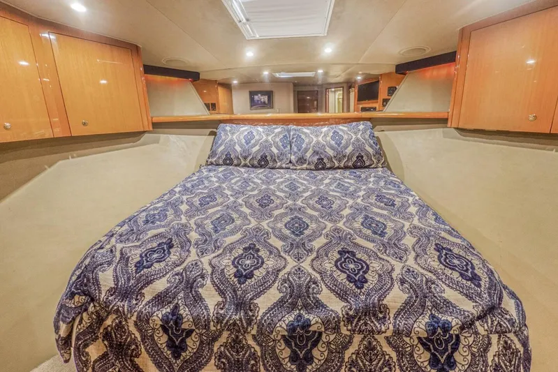 Bella Betty Yacht Photos Pics Luxurious bedroom interior of 2003 Viking 65 Enclosed Bridge yacht with patterned bedding.