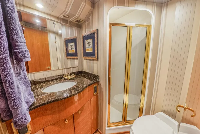 Bella Betty Yacht Photos Pics Luxurious bathroom in 2003 Viking 65 Enclosed Bridge yacht with elegant fixtures and decor.