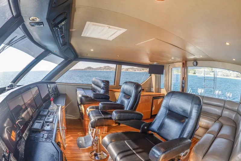 Bella Betty Yacht Photos Pics Luxurious interior of 2003 Viking 65 Enclosed Bridge yacht with leather seating and panoramic views.