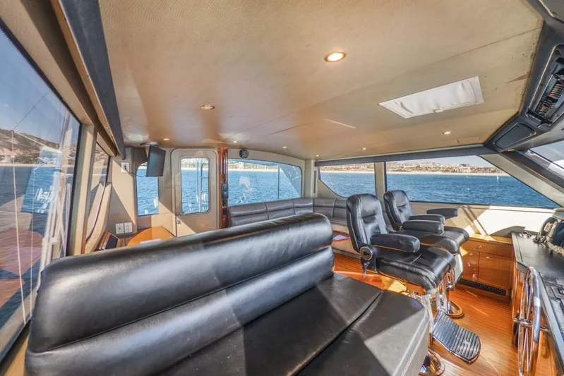 Bella Betty Yacht Photos Pics Luxurious interior of 2003 Viking 65 Enclosed Bridge yacht with leather seating and ocean view.