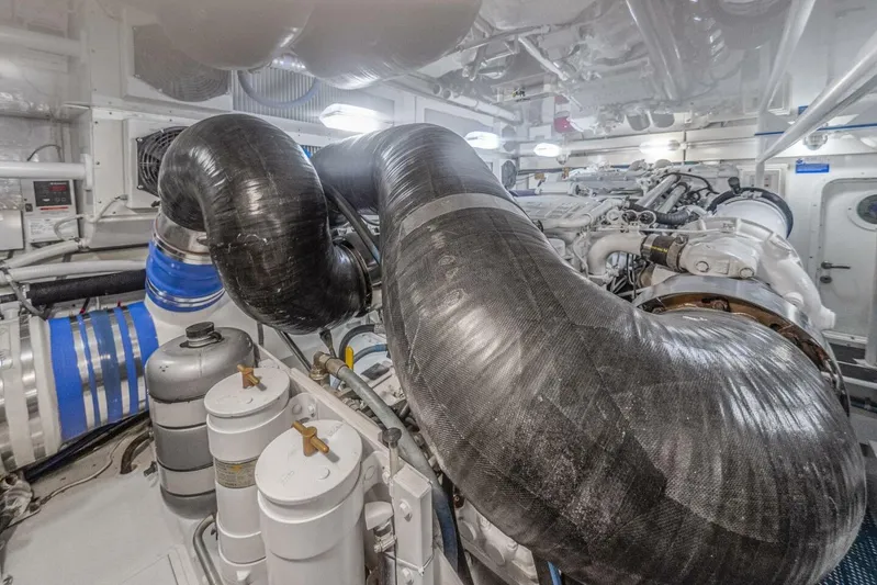 Bella Betty Yacht Photos Pics Engine room of 2003 Viking 65 Enclosed Bridge yacht, featuring complex machinery and piping.