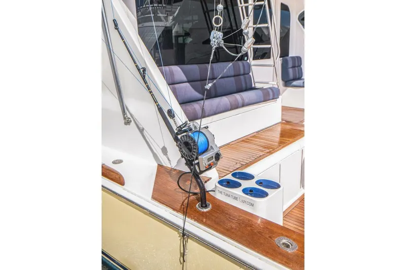 Bella Betty Yacht Photos Pics 2003 Viking 65 Enclosed Bridge yacht deck with fishing equipment and seating.