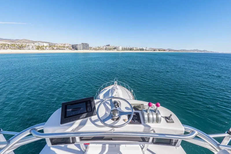Bella Betty Yacht Photos Pics Helm view from 2003 Viking 65 Enclosed Bridge yacht overlooking serene ocean and coastline.