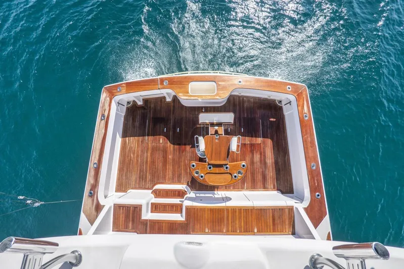 Bella Betty Yacht Photos Pics Aerial view of 2003 Viking 65 Enclosed Bridge yacht deck on blue water.