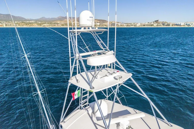 Bella Betty Yacht Photos Pics 2003 Viking 65 Enclosed Bridge yacht on blue ocean with distant coastline.