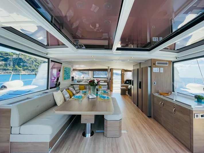 Signature Bali 5.4. (6+ 2 Cabins) Yacht Photos Pics Luxurious interior of 2022 Bali 5.4 yacht with elegant dining area and panoramic windows.