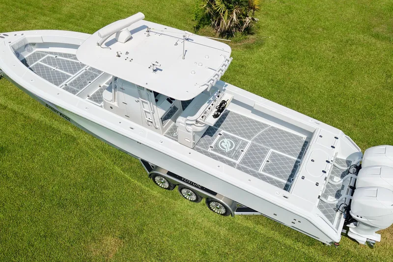  Yacht Photos Pics 2005 Venture 39 Open boat on grass, aerial view, showcasing sleek design and twin engines.