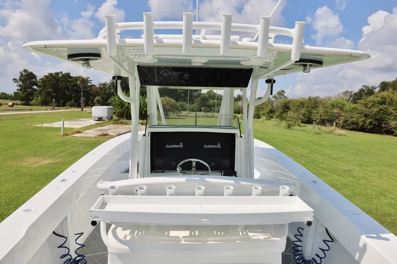  Yacht Photos Pics 2005 Venture 39 Open boat with Garmin electronics, docked on grassy area under blue sky.