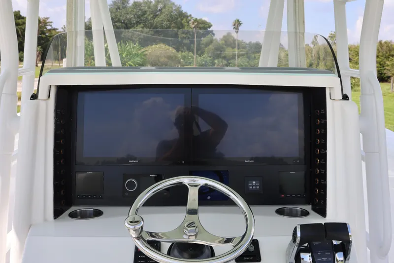  Yacht Photos Pics 2005 Venture 39 Open boat dashboard with dual screens and steering wheel.