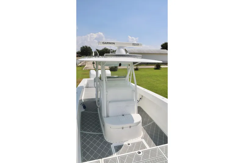  Yacht Photos Pics 2005 Venture 39 Open boat with Garmin equipment, featuring a sleek white deck and seating.