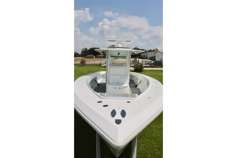  Yacht Photos Pics 2005 Venture 39 Open boat, white exterior, displayed outdoors on grass.