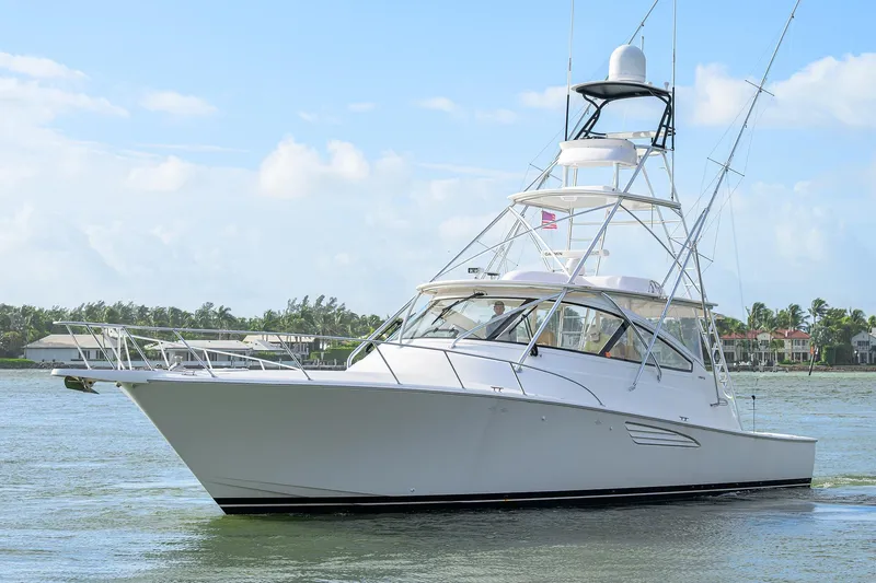  Yacht Photos Pics 2015 Viking 52 Open yacht cruising on a sunny day near coastal homes.