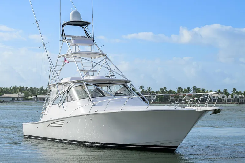  Yacht Photos Pics 2015 Viking 52 Open yacht cruising on calm waters under a clear blue sky.