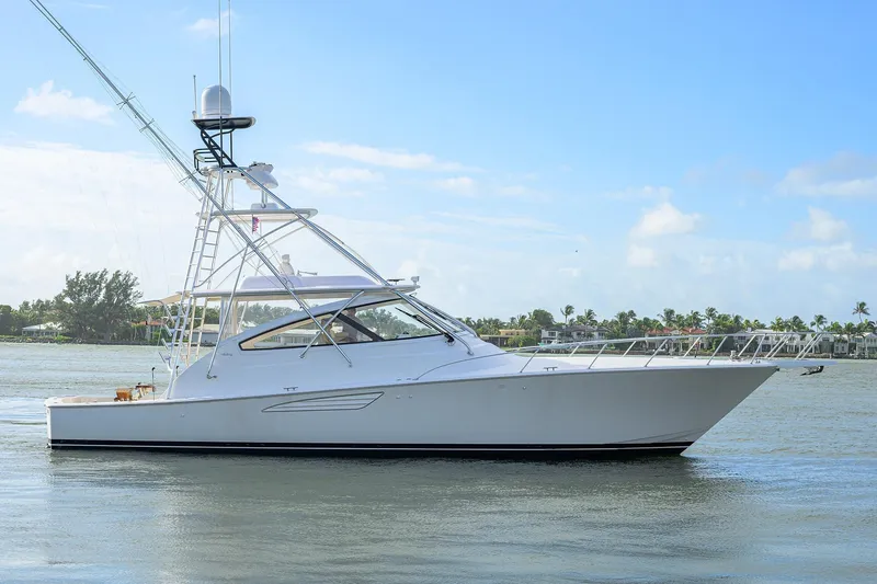  Yacht Photos Pics 2015 Viking 52 Open yacht cruising on calm waters under a clear blue sky.