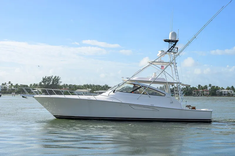  Yacht Photos Pics 2015 Viking 52 Open yacht cruising on calm waters under a clear blue sky.