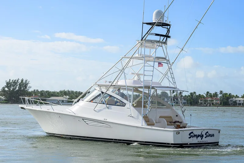  Yacht Photos Pics 2015 Viking 52 Open yacht cruising on a sunny day near coastal homes.