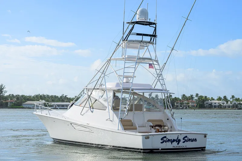  Yacht Photos Pics 2015 Viking 52 Open yacht on water, featuring a sleek design and tower, labeled "Simply Simon."